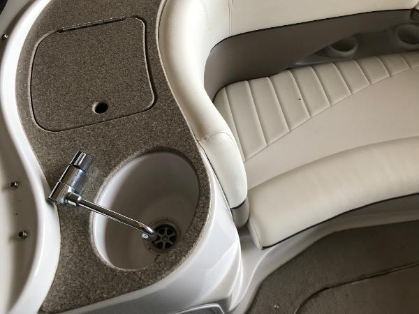 Slide: The Image of 2004 Four Winns 234 Funship interior with sink and white seating. - 17