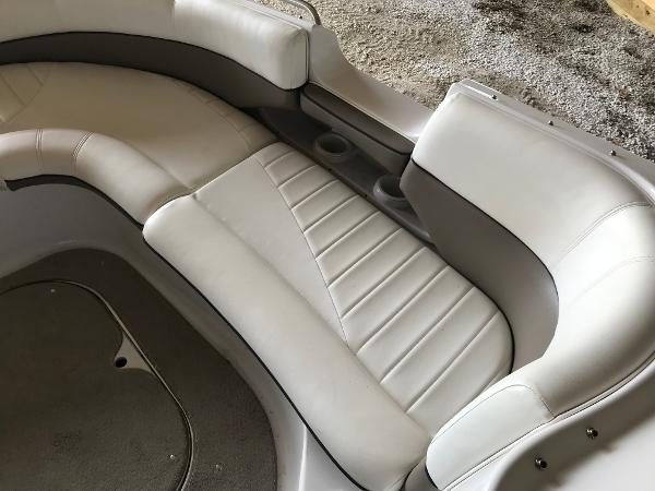 Slide: The Image of 2004 Four Winns 234 Funship boat interior with white cushioned seating and cup holders. - 19