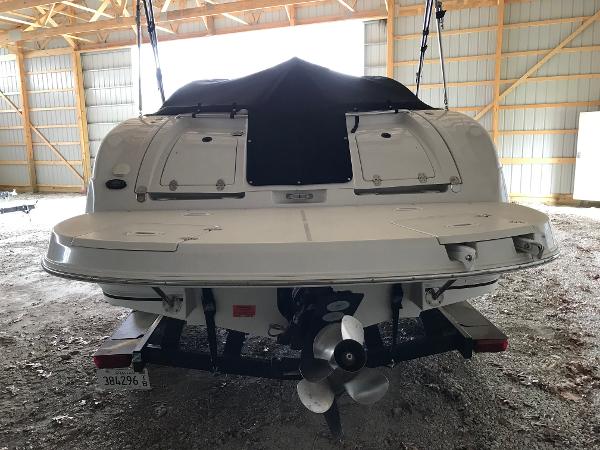 Slide: The Image of 2004 Four Winns 234 Funship boat in storage, rear view with covered deck. - 2
