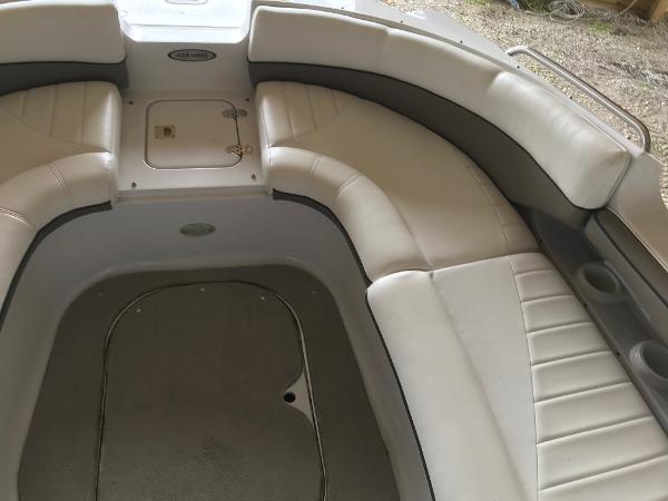 Slide: The Image of 2004 Four Winns 234 Funship boat interior with white seating and storage compartments. - 20