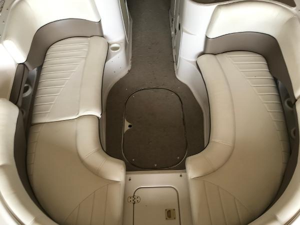 Slide: The Image of 2004 Four Winns 234 Funship interior seating with beige upholstery and spacious layout. - 21