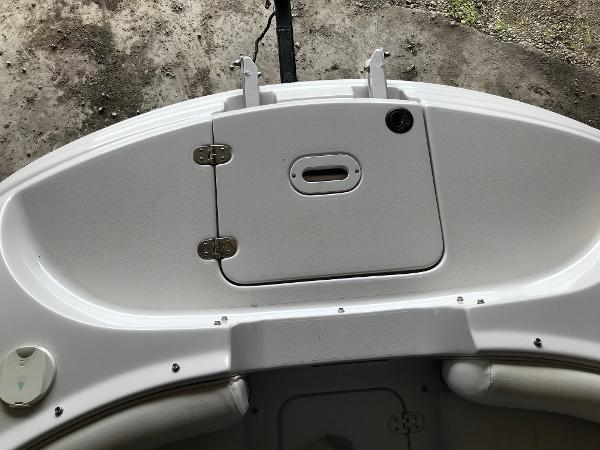 Slide: The Image of 2004 Four Winns 234 Funship boat deck with storage compartment and seating area. - 22