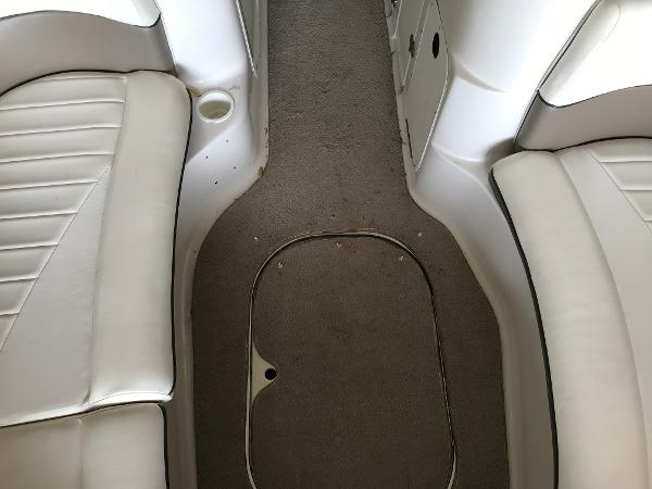 Slide: The Image of 2004 Four Winns 234 Funship interior with white seating and carpeted floor. - 24