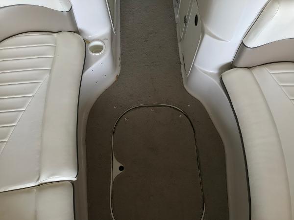 Slide: The Image of Interior view of 2004 Four Winns 234 Funship boat with white seating and carpeted floor. - 25