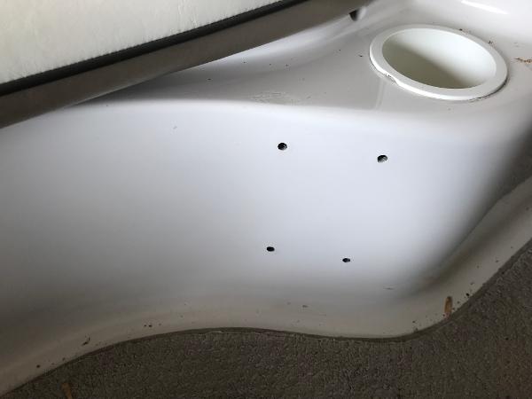 Slide: The Image of Interior detail of a 2004 Four Winns 234 Funship boat, featuring a cup holder and mounting holes. - 27