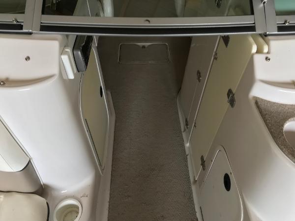 Slide: The Image of Interior view of a 2004 Four Winns 234 Funship boat, featuring storage compartments and seating area. - 30