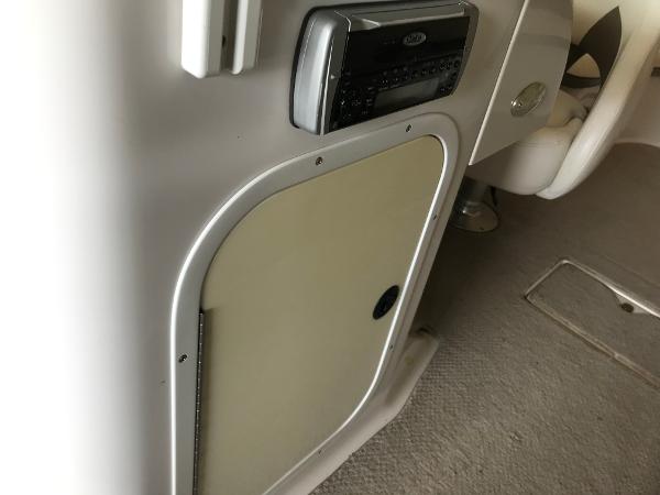 Slide: The Image of 2004 Four Winns 234 Funship interior with stereo system and storage compartment. - 32