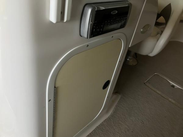 Slide: The Image of 2004 Four Winns 234 Funship interior with stereo system and storage compartment. - 33