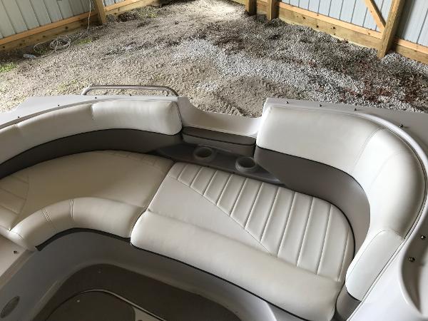 Slide: The Image of 2004 Four Winns 234 Funship boat interior with beige seating and cup holders. - 38