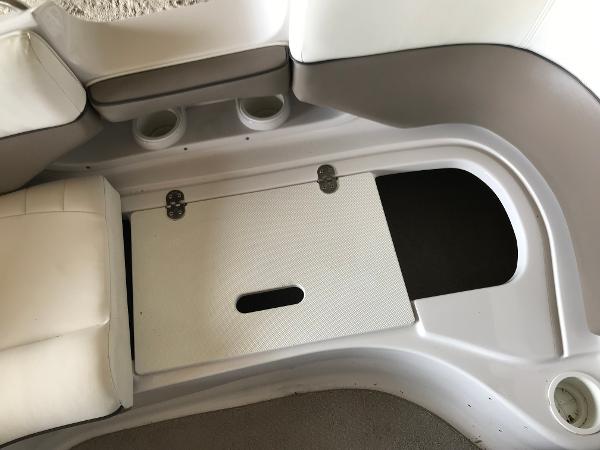 Slide: The Image of 2004 Four Winns 234 Funship boat interior with storage compartment and seating area. - 39