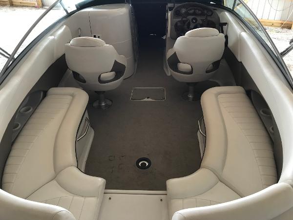 Slide: The Image of 2004 Four Winns 234 Funship boat interior with white seating and steering console. - 4