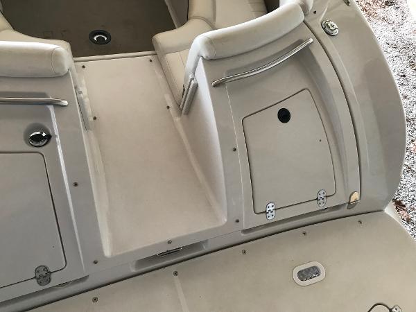 Slide: The Image of 2004 Four Winns 234 Funship boat interior with seating and storage compartments. - 42
