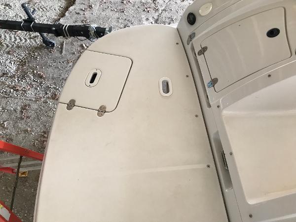 Slide: The Image of 2004 Four Winns 234 Funship boat deck with storage compartments and clean surface. - 44