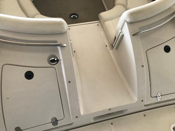 Slide: The Image of 2004 Four Winns 234 Funship boat interior with white seating and storage compartments. - 45