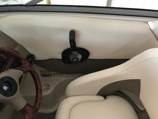 Slide: The Image of 2004 Four Winns 234 Funship boat interior with steering wheel and throttle control. - 7
