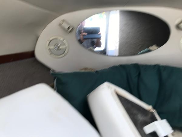 Slide: The Image of Interior cabin of a 2002 Four Winns 245 Sundowner boat with mirror and cushions. - 17