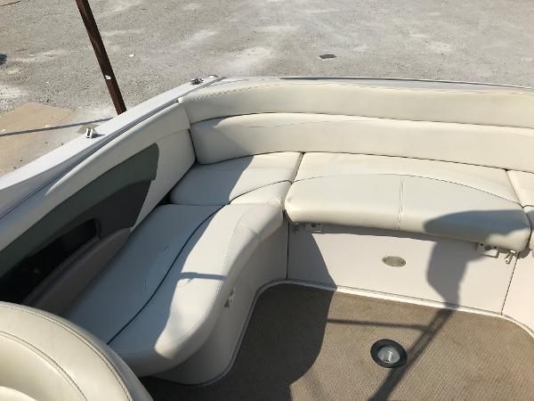 Slide: The Image of 2002 Four Winns 245 Sundowner boat interior with beige leather seating. - 6