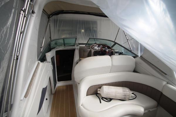 Slide: The Image of 2004 Four Winns 268 Vista boat interior with white seating and wooden flooring. - 10