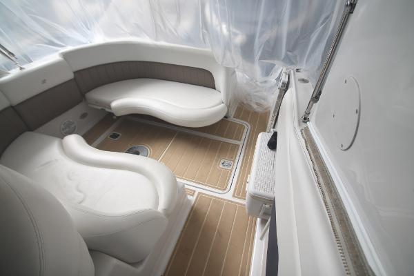 Slide: The Image of 2004 Four Winns 268 Vista boat interior with white seating and wood-style flooring. - 11