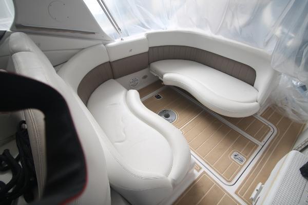 Slide: The Image of 2004 Four Winns 268 Vista boat interior with white seating and wood flooring. - 13