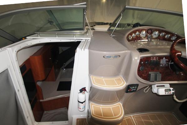 Slide: The Image of 2004 Four Winns 268 Vista boat interior with helm, steps, and cabin entrance. - 14