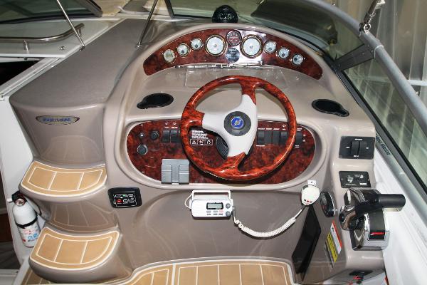 Slide: The Image of 2004 Four Winns 268 Vista boat dashboard with wood accents and modern controls. - 16