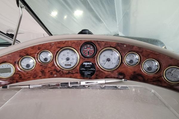 Slide: The Image of Dashboard of 2004 Four Winns 268 Vista boat with wood finish and multiple gauges. - 17
