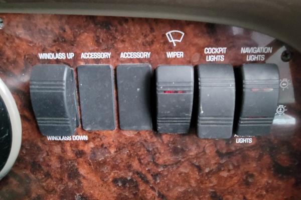 Slide: The Image of Control panel of a 2004 Four Winns 268 Vista boat with labeled switches. - 22