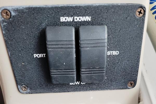 Slide: The Image of Control panel of a 2004 Four Winns 268 Vista boat with bow adjustment switches. - 24