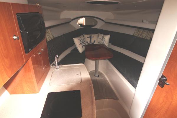 Slide: The Image of 2004 Four Winns 268 Vista cabin interior with kitchenette and seating area. - 26