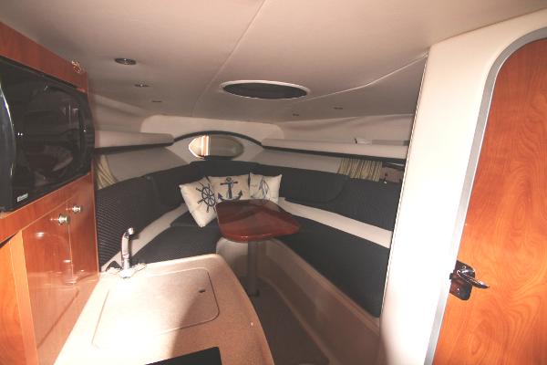 Slide: The Image of 2004 Four Winns 268 Vista cabin interior with cozy seating and nautical decor. - 27