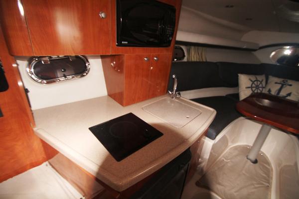 Slide: The Image of 2004 Four Winns 268 Vista cabin interior with kitchenette and seating area. - 30