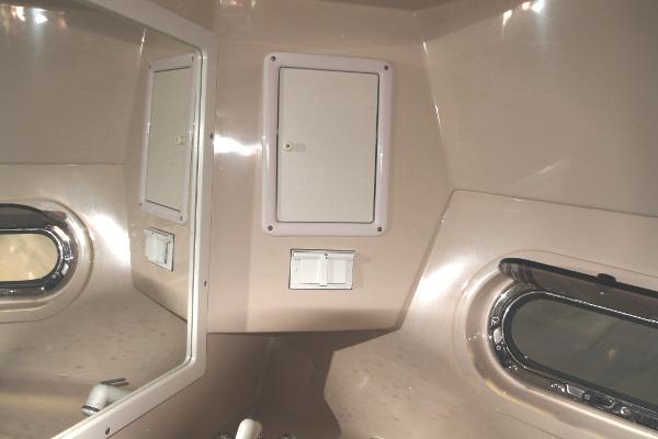 Slide: The Image of 2004 Four Winns 268 Vista cabin interior with porthole and storage compartment. - 36