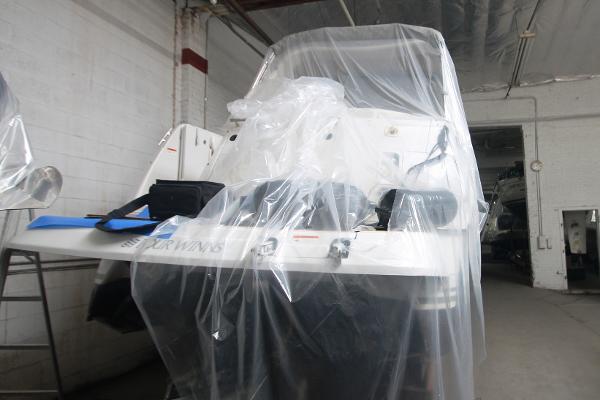 Slide: The Image of 2004 Four Winns 268 Vista boat covered in protective plastic in a storage facility. - 38