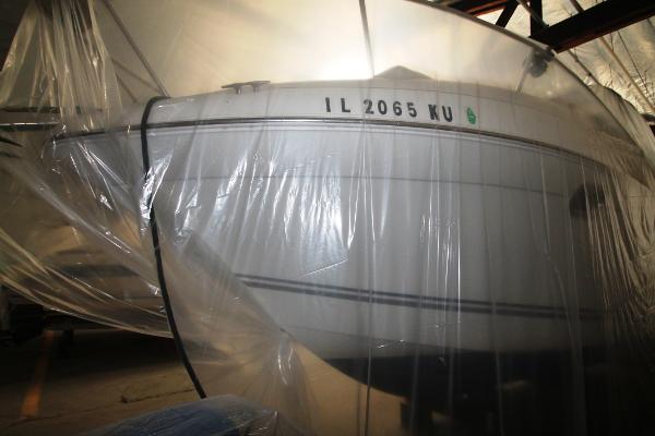 Slide: The Image of 2004 Four Winns 268 Vista boat wrapped in protective plastic in storage. - 39