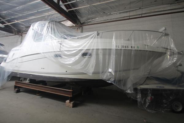 Slide: The Image of 2004 Four Winns 268 Vista boat covered in plastic, stored indoors. - 40