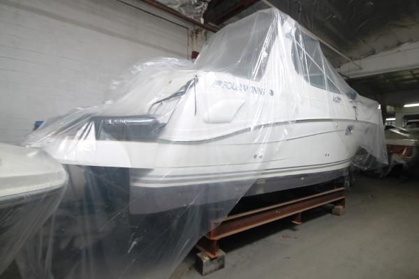Slide: The Image of 2004 Four Winns 268 Vista boat covered in protective plastic wrap indoors. - 42