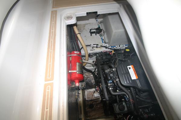 Slide: The Image of Engine compartment of a 2004 Four Winns 268 Vista boat, showing mechanical components and hoses. - 45