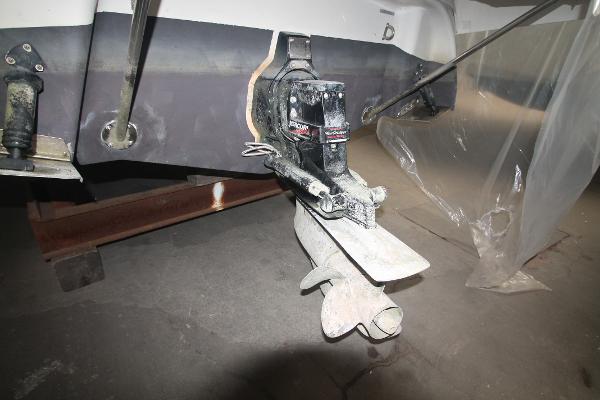 Slide: The Image of 2004 Four Winns 268 Vista boat propeller and stern drive in a workshop setting. - 46