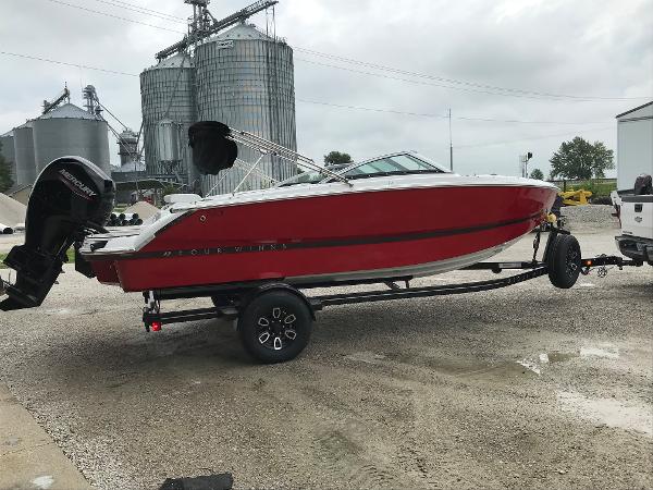 Slide: The Image of 2023 Four Winns H1 OB boat in red on a trailer. - 1