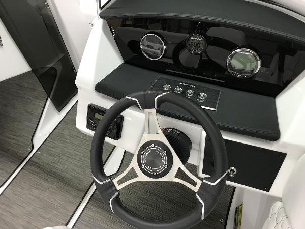 Slide: The Image of 2023 Four Winns H1 OB boat dashboard with steering wheel and instrument panel. - 10