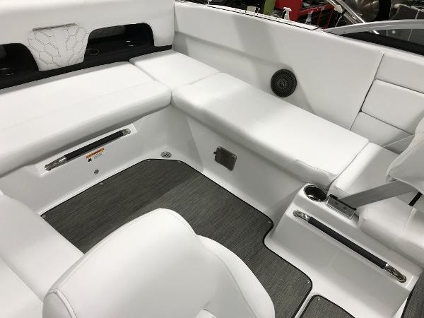 Slide: The Image of 2023 Four Winns H1 OB boat interior with white seating and grey flooring. - 11