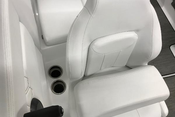 Slide: The Image of 2023 Four Winns H1 OB boat interior with white seating and cup holders. - 15