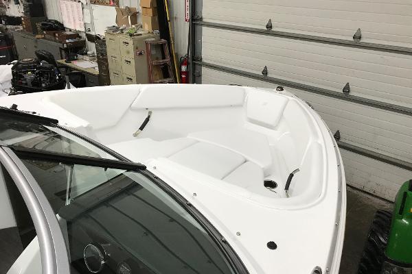 Slide: The Image of 2023 Four Winns H1 OB boat interior in a garage. - 16