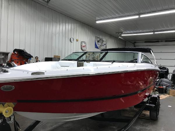 Slide: The Image of 2023 Four Winns H1 OB boat in a garage. - 2