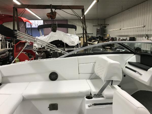 Slide: The Image of 2023 Four Winns H1 OB boat interior in a workshop. - 5
