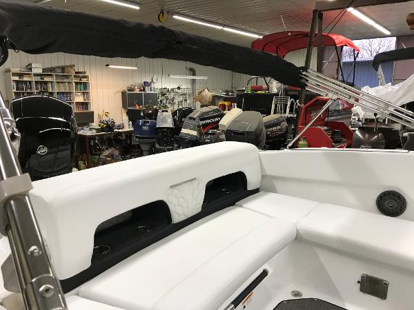Slide: The Image of 2023 Four Winns H1 OB boat interior in a workshop with various equipment. - 6
