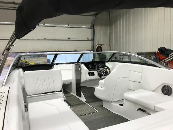 Slide: The Image of 2023 Four Winns H1 OB boat interior with white seating and modern dashboard. - 8