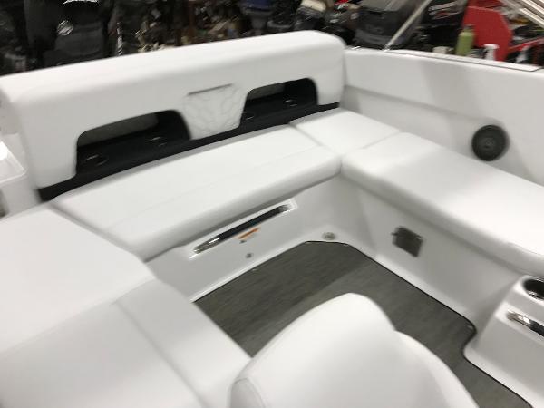 Slide: The Image of 2023 Four Winns H1 OB boat interior with white cushioned seating. - 9