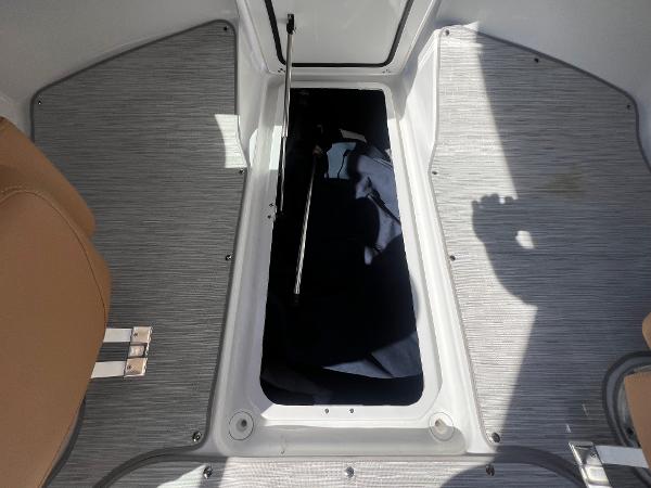 Slide: The Image of 2023 Four Winns H4 boat storage compartment with open hatch. - 29